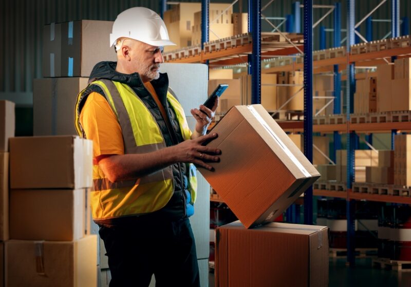 Man,In,Customs,Warehouse.,Storekeeper,With,Box.,Warehouse,Worker,Holds