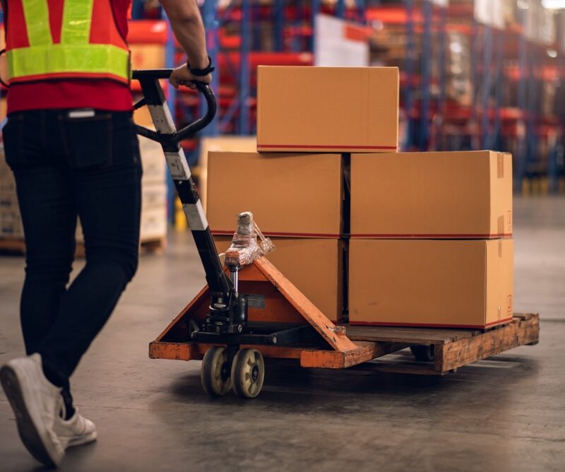 Factory,Worker,Using,Hand,Pallet,Truck,To,Move,Carton,Box